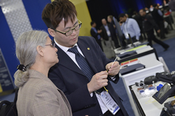 An exhibitor shows off a product at OFC 2014.